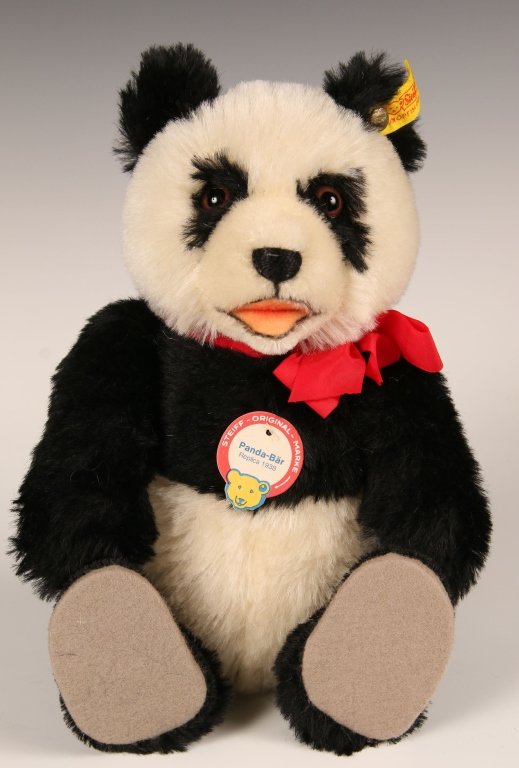 STEIFF REPLICA PANDA BEAR: 1985 replica of the 1938 edition, 0178/29, button in ear with yellow label, paper chest and hang tags, measures 11 inches (29 cm).