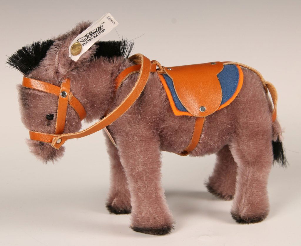 STEIFF MUSEUM COLLECTION MECHANICAL DONKEY LIMITED: 1988 replica of the 1931 historical piece, mechanism in the tail moves the head, button in ear with white label, 0126/20, paper chest tag, original box, limited edition of 4000, donkey measures 7 x 8