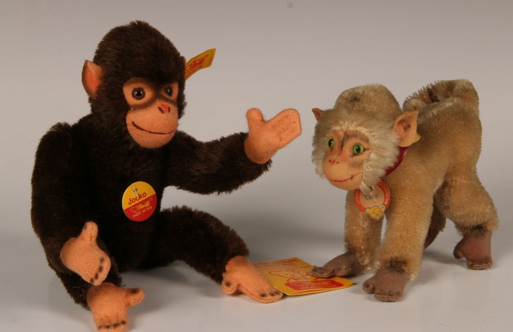 STEIFF COCO AND JOCKO CHIMPANZEES: Vintage Coco the Chimpanzee 1310,0 in brown and white, non-jointed, button in ear with yellow label, leather collar with paper chest tag, measures 4 inches (10 cm) standing. Plus Jocko the Chimpanzee 