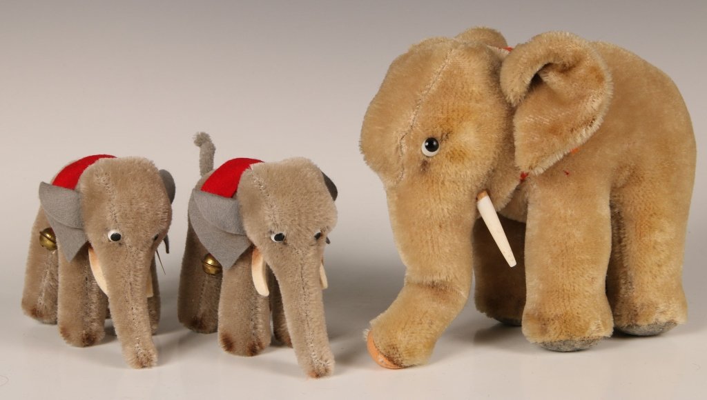 STEIFF COZY TRAMPY ELEPHANT & TWO HERMANN ELEPHANTS: Vintage Steiff Cosy Trampy Elephant with wooden tusks, no button in ear or labels, measures 7 inches, small tear on the end of his trunk and wear on his foot pads. Plus two small Hermann elephants wit