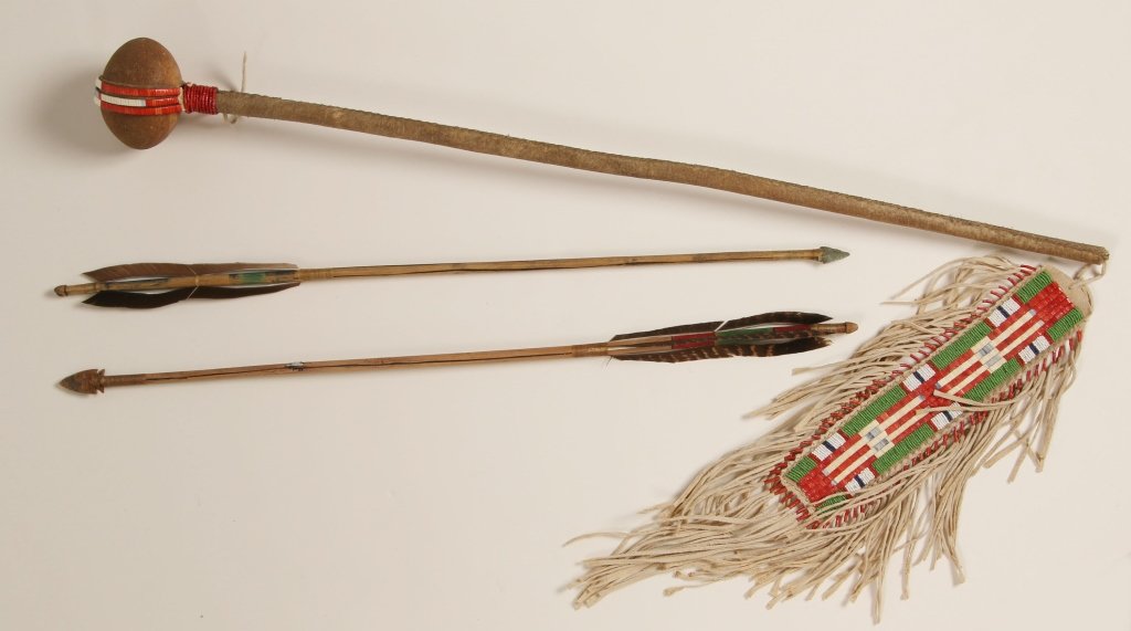 A CONTEMPORARY SIOUX WAR CLUB WITH QUILL AND BEADWORK: With quilled and beaded buckskin drop. The club itself measures 31 inches and the drop 15 inches. Included are two arrows with chipped stone points, 25 inches long.