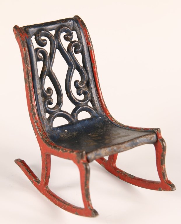 J&E STEVENS CAST IRON TOY DOLL HOUSE ROCKING CHAIR: Attributed to J&E Stevens toy company, Cromwell, CT. Pictured in their catalog as No. 114, rocker. Measures 3.5 x 2.25 x 3.25 inches.