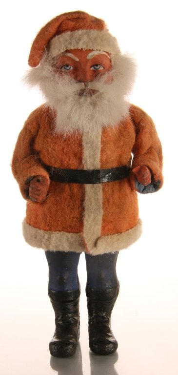 C. 1900 GERMAN PAPIER MACHE SANTA CLAUS CANDY CONTAINER: Classic figure with white fur beard, marked Germany, separates at the waist to reach the candy. Measures 8 x 4.25 inches.