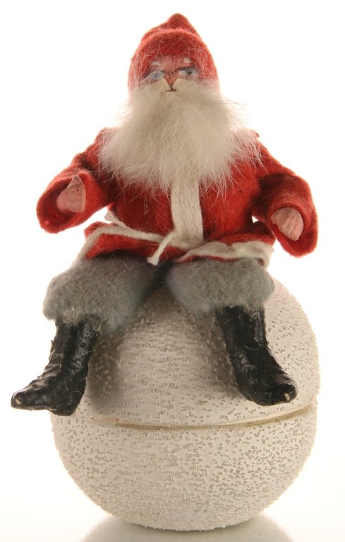 SANTA CLAUS ON SNOW BALL GERMAN CANDY CONTAINER: Papier mache' Santa with white fur beard on snow ball candy container marked Germany. Measures 6 x 3 inches.