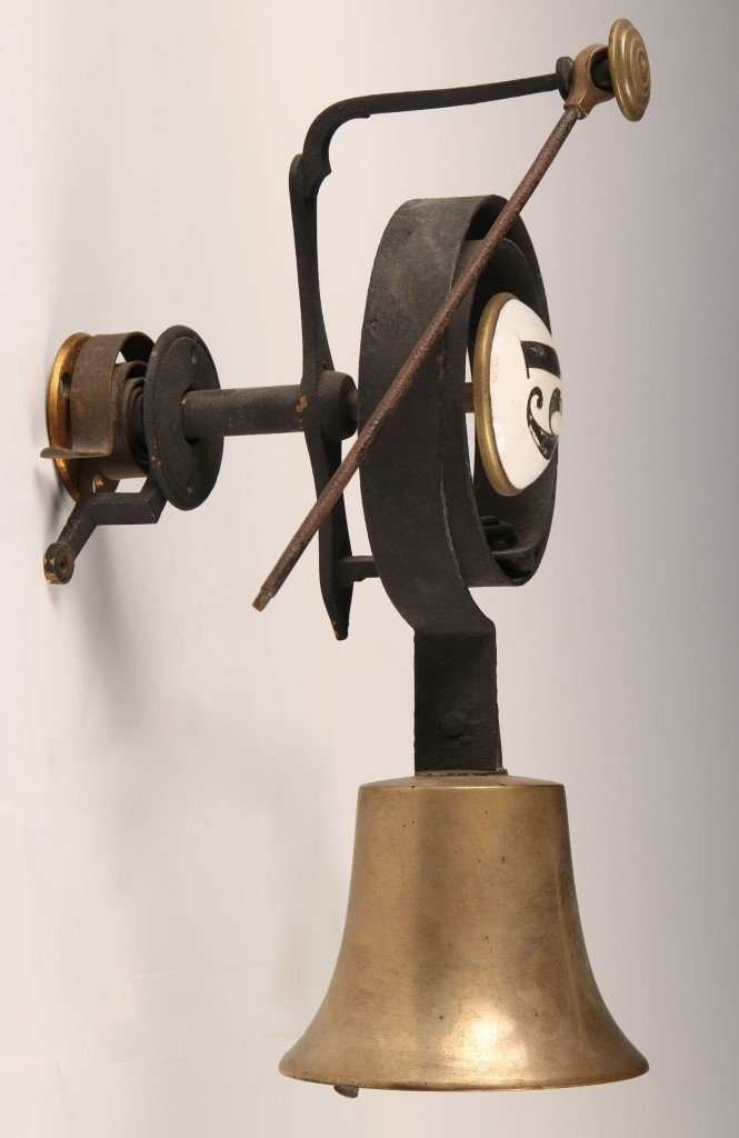 BRASS AND IRON DOOR BELL PAINTED PORCELAIN NUMERAL: Circa 1880s. Measures 12.5 x 7 inches.