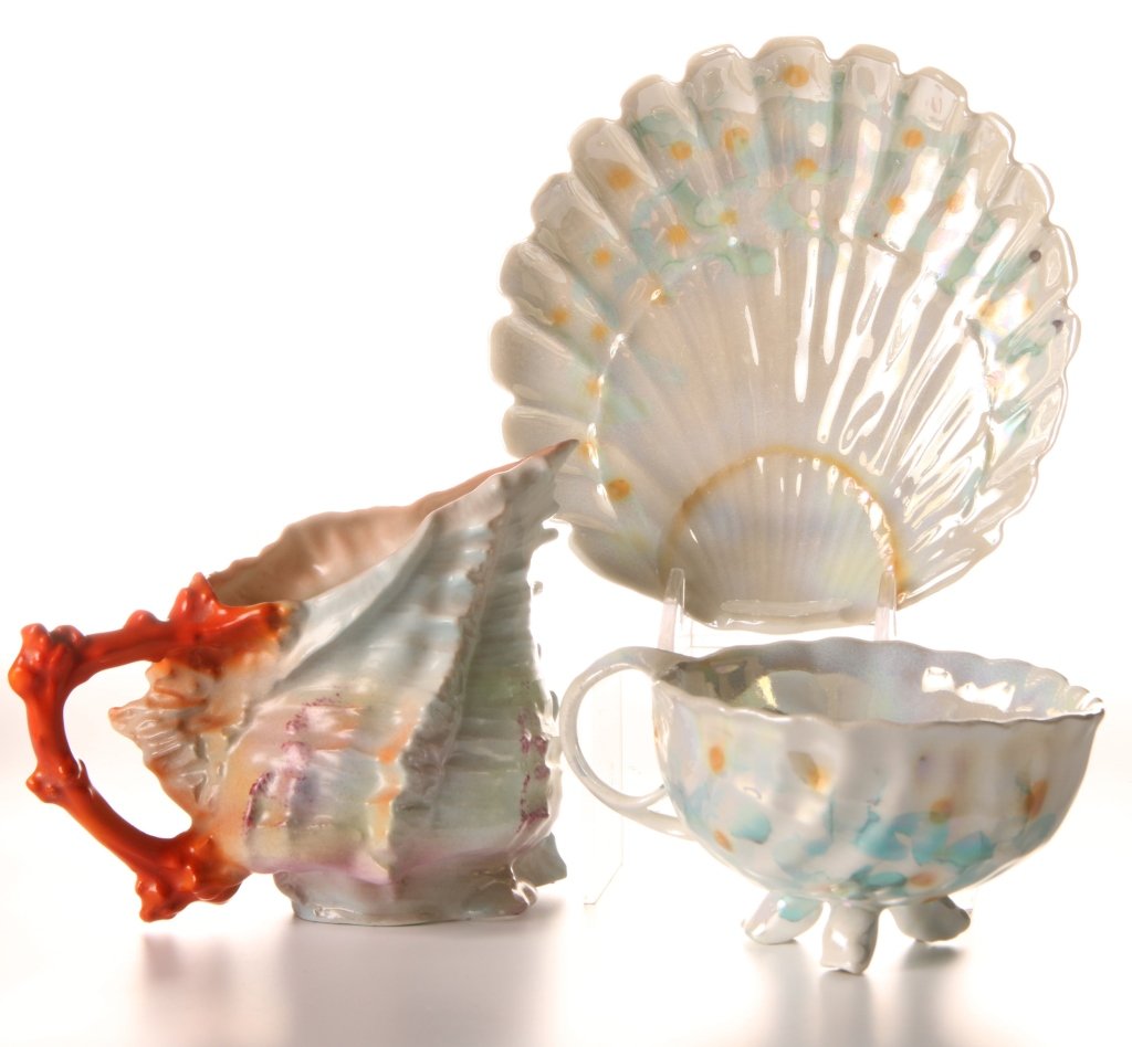 ROYAL BAYREUTH FIGURAL SHELL CUP & SAUCER & CREAMER: Spiky shell demi cup and saucer with lustre glaze, marked Deponiert on the saucer, cup measures 2.25 x 4.5 inches, saucer measures 5 inches. Plus a Spiky Shell creamer, marked with blue ink stamp #9, 