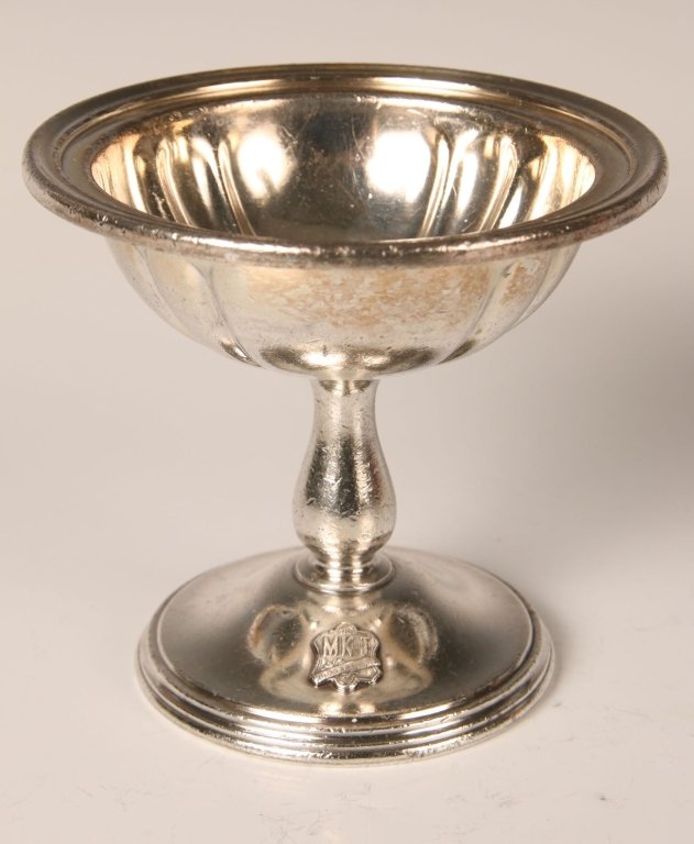 MISSOURI KANSAS TEXAS MK&T RAILROAD SILVER ICE CREAM: Marked 'R. Wallace, 0279-5, silver soldered, M.K.T.,' applied MK&T shield on foot. Measures 4 x 4.25 inches. Shows some wear and utensil marks, good overall.