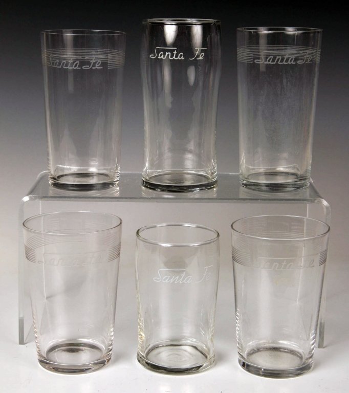 SIX PIECES SANTA FE RAILROAD GLASSWARE: Four different sizes (4 inches to 5.25 inches), with etched Santa Fe logos. No chips, cracks or repairs.