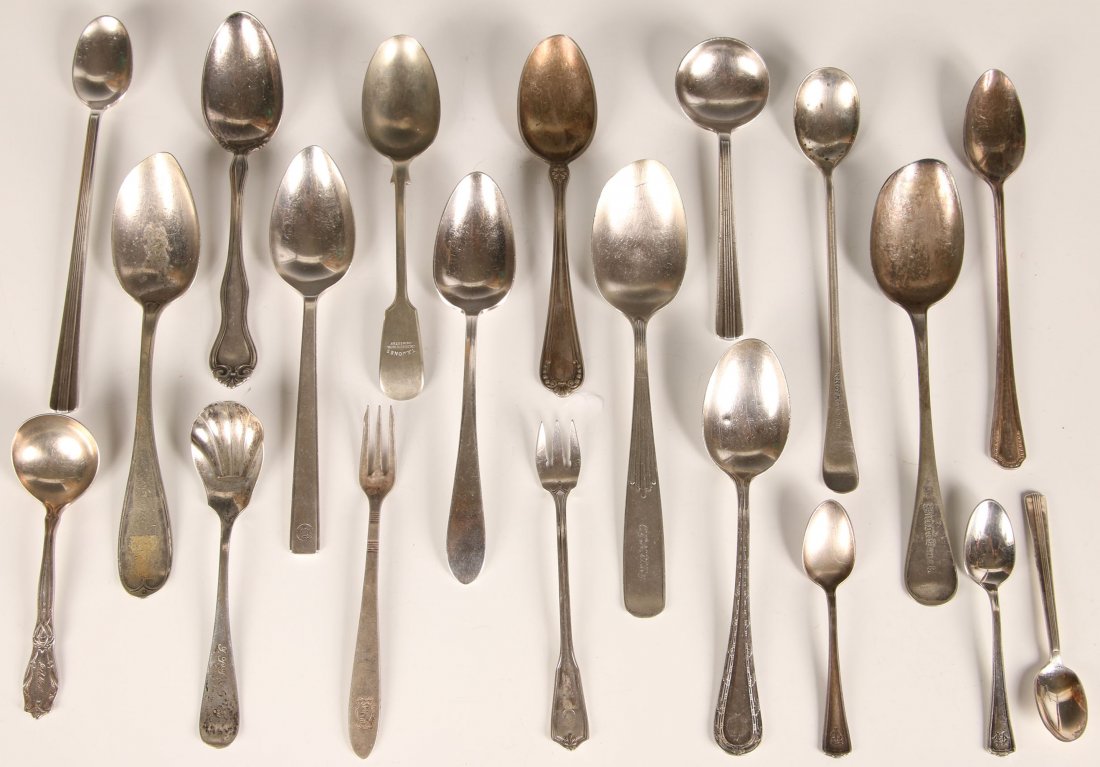 TWENTY RAILROAD AND HOTEL FLATWARE SERVING PIECES: Includes nine serving spoons for Union News, Virginia Depot, St. Louis & Peoria Packet, CYNW Ry, Northern Pacific, Western Pacific, NYNH&H RR, JJ Grier. Also two cocktail forks, Adolphus, Skirvin; and