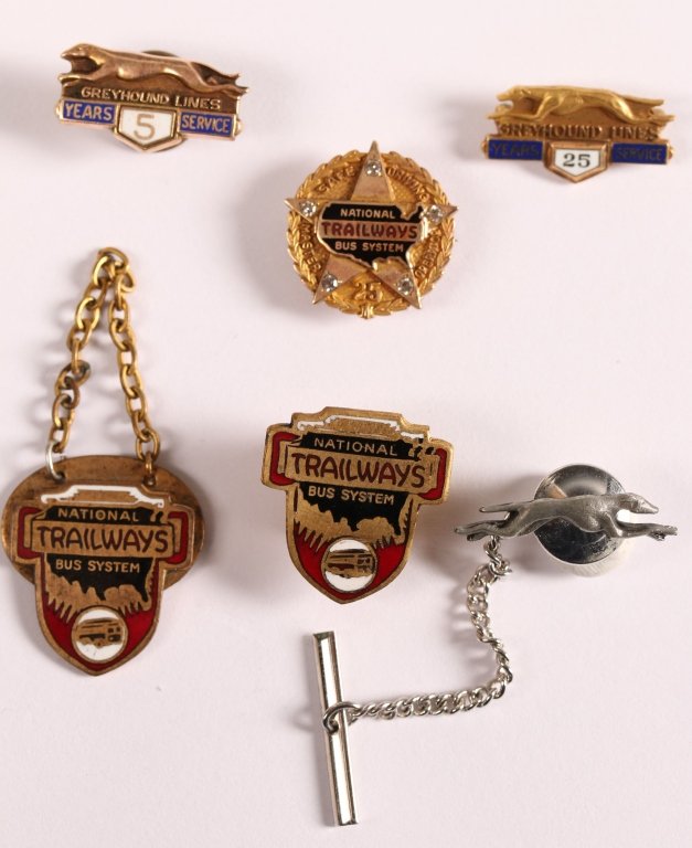EIGHT ENAMELED BUS LINES SERVICE PINS: Including Trailways and Greyhound Service pins with enamel decoration. The 25 years Trailways Safe Driving pin is set with five diamonds. Very good condition throughout.
