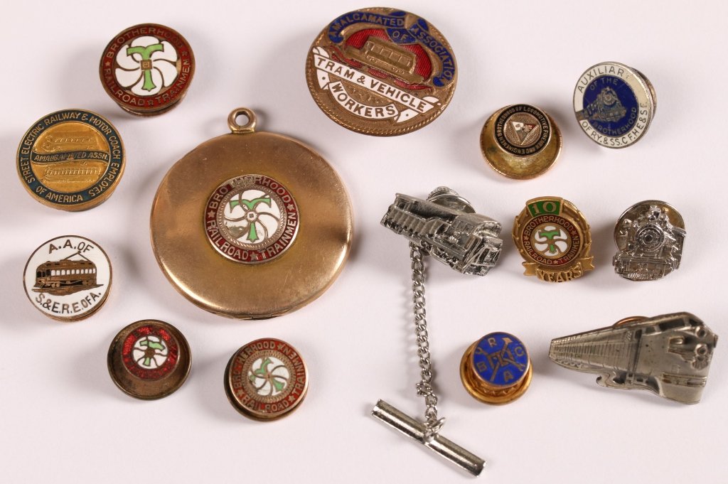 GROUP OF RR WORKERS' FRATERNAL ORGANIZATION PINS &: 14 pieces, including lapel pins, tie tacks, and locket for various organizations including Brotherhood of Railroad Trainmen, Brotherhood of Locomotive Firemen and Engineers, circa 1920. Brotherhood of