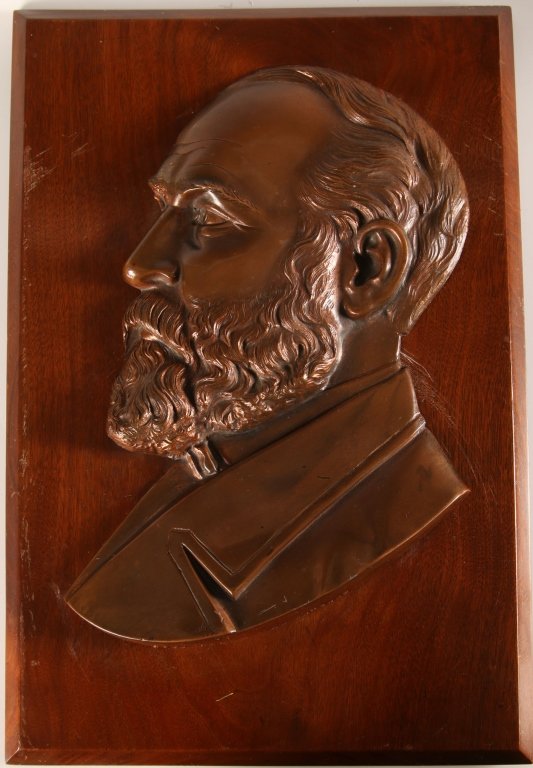 SPELTER PLAQUE OF PRESIDENT JAMES. A GARFIELD: Copper flashed spelter on a walnut back board. The metal bust is dated copyright May 18, 1887. As twentieth President of the United States, Garfield was assassinated in 1881. Measures 19 x 12.75 inche