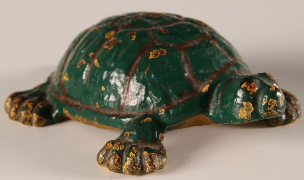 CAST IRON TURTLE DOOR STOP: With good old enamel green paint and the showing through of a previous yellow. Measures 2.5 x 7.25 x 5.5 inches.