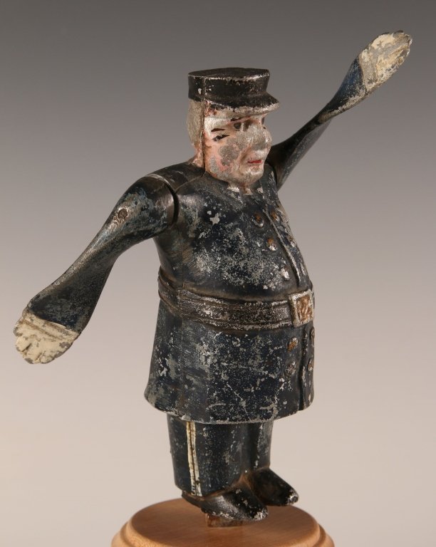 CIRCA 1920s MODEL A WHIRLIGIG HOOD ORNAMENT: Painted aluminum model of Policeman. These were made by Kansas City Co. Measures 9.5 x 4 inches.