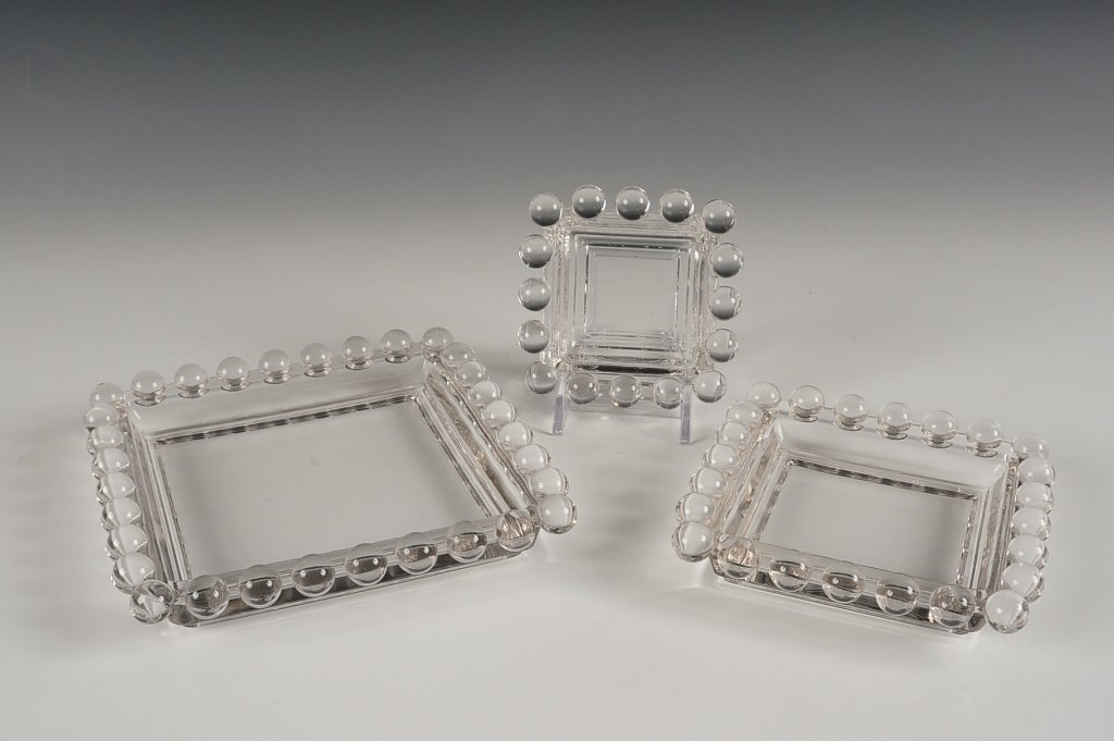 IMPERIAL CANDLEWICK THREE PC. SQUARE ASHTRAY SET: 400/650, three pieces ranging in size from 5.5 x 5.5 inches, down to 3 x 3 inches.