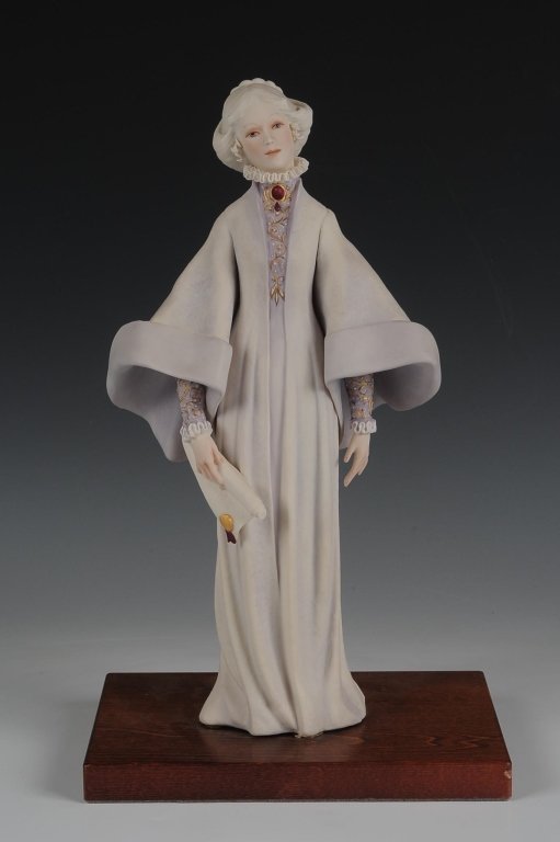 1973 CYBIS PORCELAIN 'PORTIA' FIGURE, LIMITED EDITION: Limited edition of 750, signed on the back and numbered #637, faintly dated 1973 on the document she holds in her hand, wooden base, measures 14 inches.