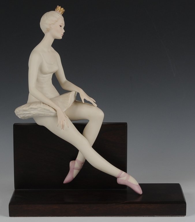 CYBIS PORCELAIN 'BALLERINA ON CUE' FIGURE, RETIRED: Signed on the porcelain base, mounted on a wooden base, measures 12.75 inches.