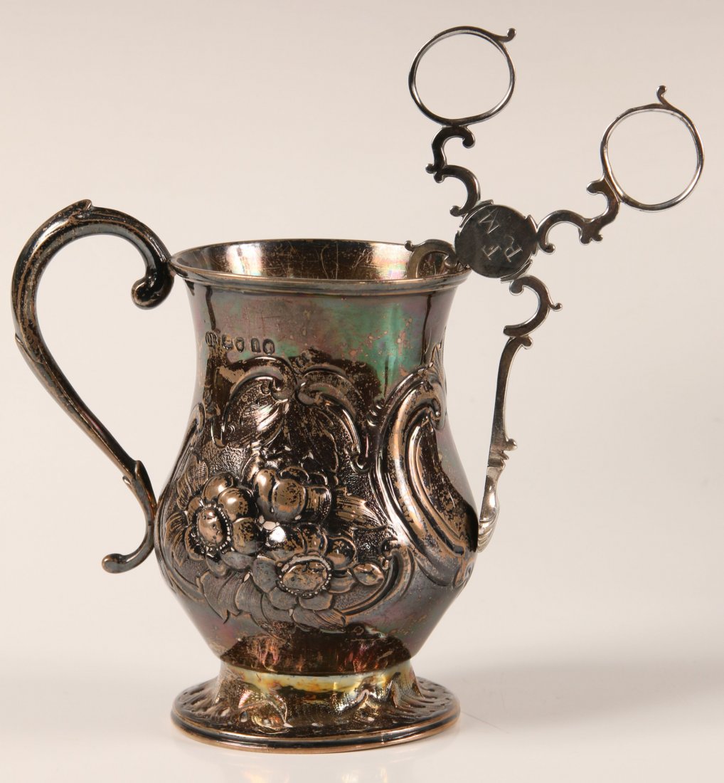 1861 LONDON STERLING SILVER CUP: A small chased silver footed cup with London Hallmarks for 1861 plus a pair of shell motif sugar nips bearing only rampant lion and maker's mark H.M. The cup measures 4 x 4 inches, and the nips measur