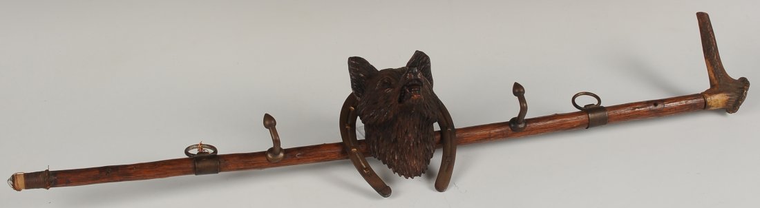 ANTIQUE WALKING STICK WITH BLACK FOREST CARVED FOX &: A great hat or tack rack fashioned from an antique stag handle walking stick with two hanging rings and hooks. In the center is a brass horseshoe centered by a Black Forest carved fox head previously 