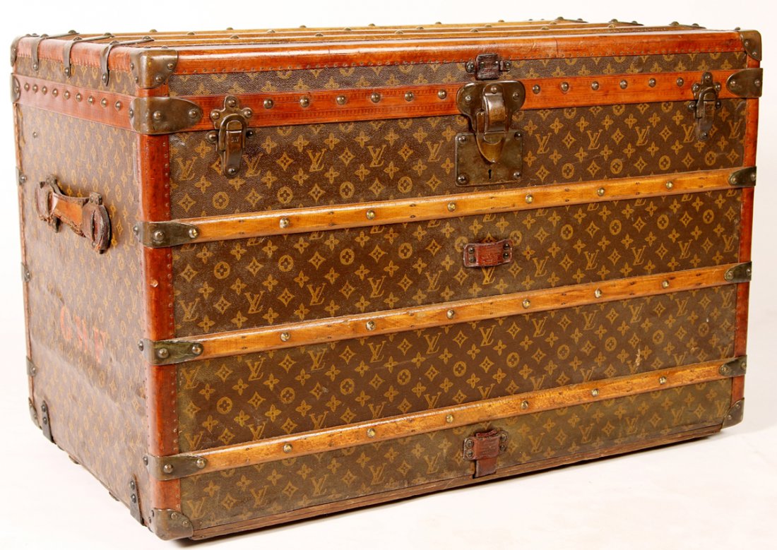 LOUIS VUITTON CANVAS & LEATHER STEAMER TRUNK WITH: Classic monogram painted canvas with leather and brass trim. Numbered 043461 on the lock plate and marked 'Louis Vuitton' on each lock plate rivet as well as the leather strap guides and paper label i
