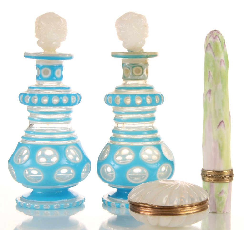 LOT OF FINE SMALL ANTIQUE OBJECTS: Including a painted porcelain asparagus form box, a circular French opaline box with swirl pattern and overlaid glass scent bottles with ram's head stoppers. One bottle has damage. Group of four rangi