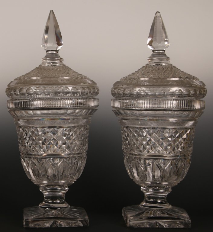 PAIR 24-INCH 19TH C. ANGLO IRISH CRYSTAL CHESTNUT URNS: A fine large pair of 19th century wheel cut crystal urns. Each decorated with a series of cross-hatch designs, bull's-eyes, zipper band, ribs and feathers. Each measures 24.25 x 9.5 inches.