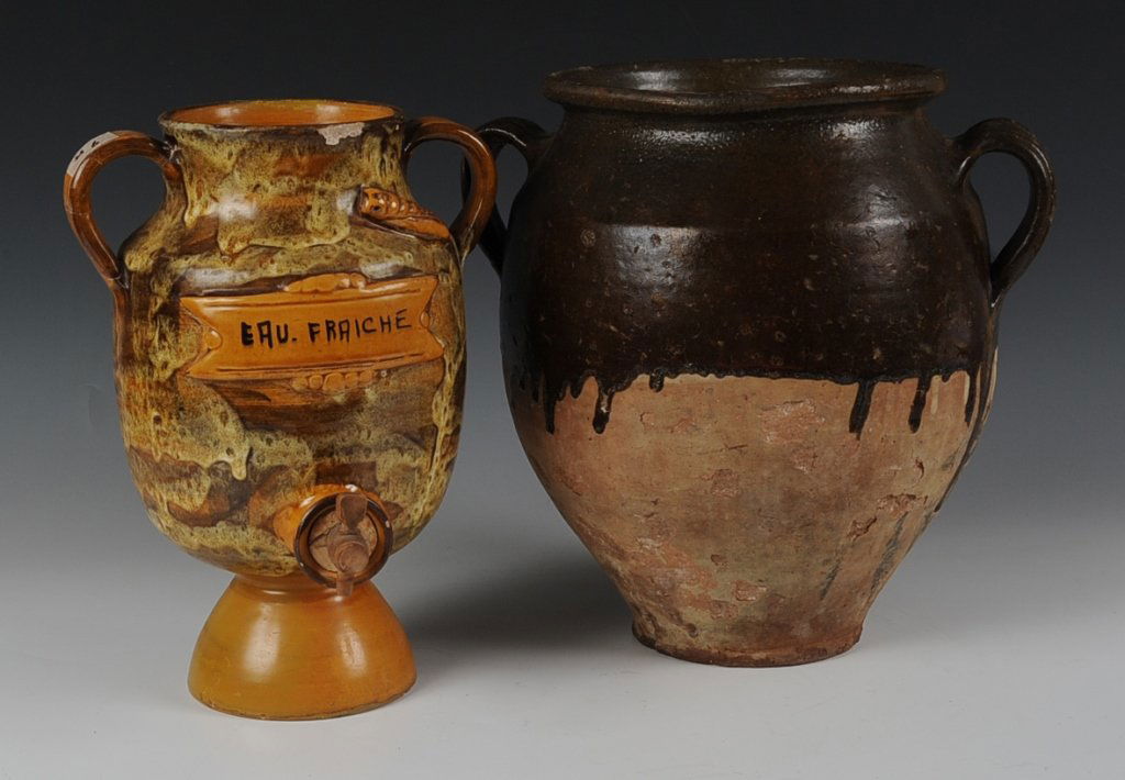 FRENCH REDWARE POTTERY CONFIT JAR: A two-handled confit jar plus a glazed urn with handles and spigot. Two pieces, with the smaller piece measuring 12 x 8.5 inches and the larger piece measures 13 x 9 inches.
