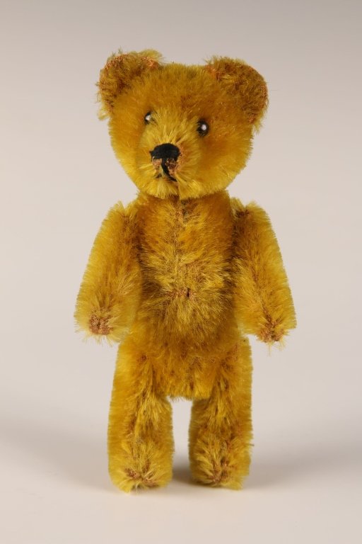 CIRCA 1930s SCHUCO TEDDY BEAR PERFUME: Golden mohair, black stitched nose and mouth, jointed body and removable head with glass perfume flask and cork stopper, measures 5 inches.