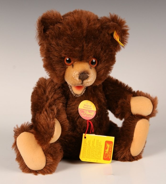 STEIFF BRUNO JOINTED BEAR, 0223/30: Glass eyes, vertically stitched nose, dark brown fur, felt paw pads, button in ear, yellow label, paper chest tag, measures 12 inches (30 cm) standing.