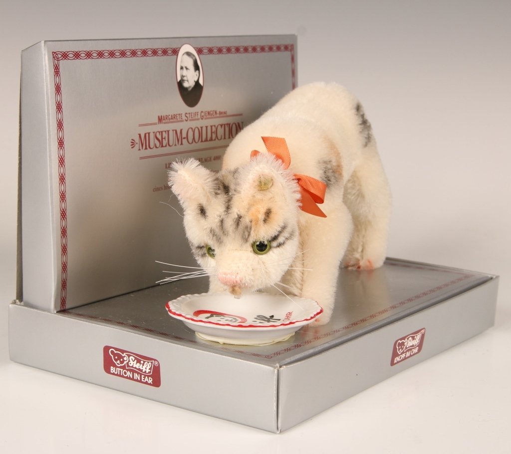STEIFF MUSEUM COLLECTION DRINKING CAT LIMITED EDITION: 1990 replica of the 1933 historical piece, with ceramic dish, button in ear, original numbered box, limited edition of 4000, cat measures 4 x 8 inches.