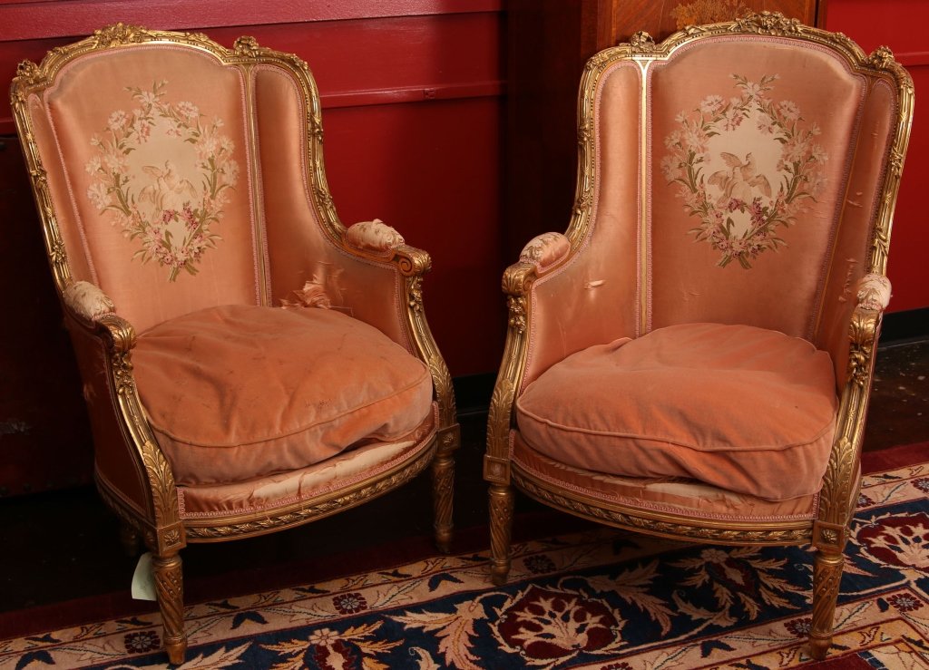 PAIR C. 1900 FRENCH LOUIS XVI SILK BROCADE BERGERE ARM: Carved and gilded wood frames in the Louis XVI style, silk brocade covering with a separate down cushion. Each measures 42 x 26.59 x 21 inches, with a 9 inch drop to floor from top of cushion.
