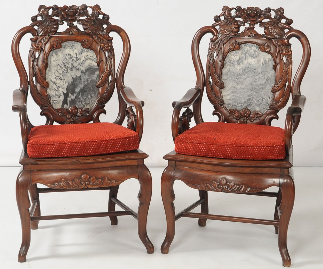 PAIR OF EARLY 20TH CENTURY CHINESE CARVED ROSEWOOD ARM: Each measures 41 x 22.5 x 17 inches.
