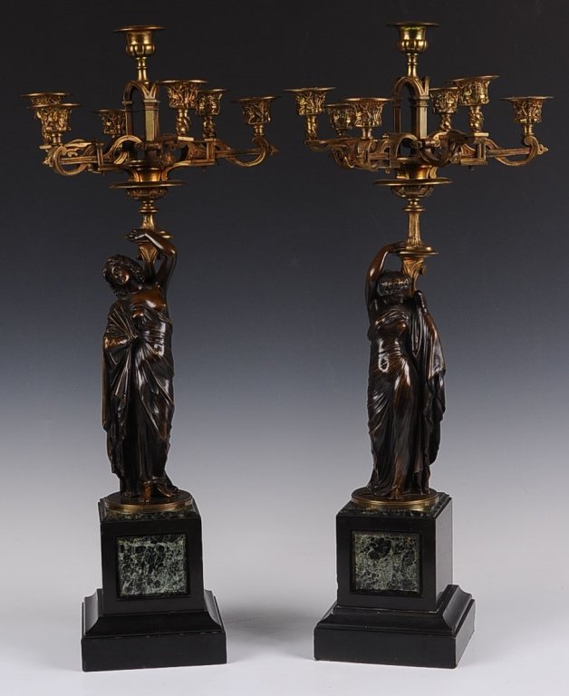 AFTER JEAN-JACQUES PRADIER (1792 - 1852) 19TH C. BRONZE: A pair of late 19th century French gilt bronze seven light candelabra on patinated bronze figural standard in the form of a classical maiden standing on square black slate base with green marble plaqu