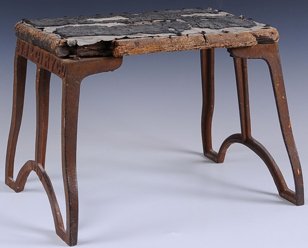 EARLY ST. JOSEPH & GRAND ISLAND RAILROAD STEP STOOL: An early unrestored cast iron base step stool with original wood platform. Cast iron ends with in embossed railroad call letters and numbers 122M and founders monogram of conjoined letters.