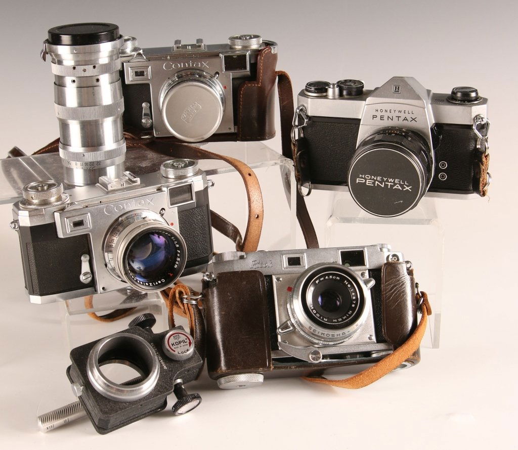 FIVE VINTAGE CAMERAS AND LENSES INCL ZEISS CONTAX: Zeiss ikon Contaxct, Riko and Pentax brands ranging in size from 1.5 x 1.5 inches up to 4.25 x 6.5 inches.