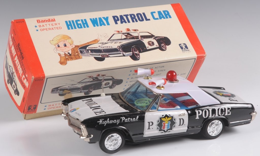 BATTERY OPERATED JAPANESE HIGHWAY PATROL CAR: Bandai number 4204 Bump And Go battery-operated highway patrol car based on the two-door 1966 Buick Riviera. 'With Screaming Siren.' Measures 4.5 x 11.25 x 4.75 inches. We ship in-house for all but ve