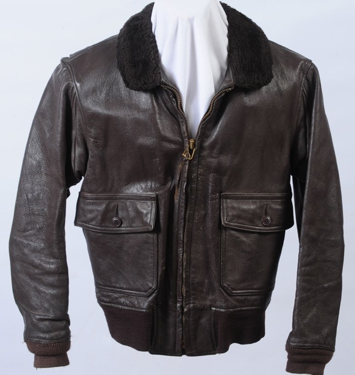 USN TYPE G1 FLYERS COAT, SIZE 42: Classic brown goat skin flight jacket with mouton collar, woven cuffs and waist band with functional zipper and '72 dated makers military specification label. Star Sportswear mfg. company jacket flyer