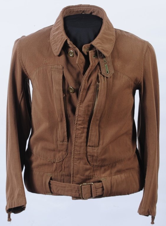 WWII JAPANESE ARMY PILOTS TWO PIECE FLIGHT SUIT: Brown gabardine wool jacket, zippered cuffs and chest pockets with button fronts, adjustable waist belt. Includes matching trousers with zippered pockets and large printed nomenclature inside. Small t