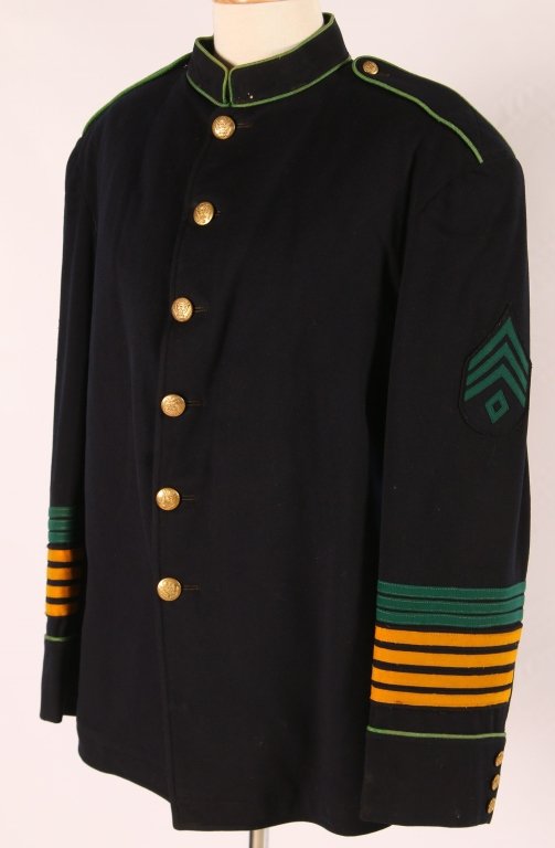 1902 ARMY FIRST SERGEANTS DRESS BLUE SERVICE COAT: Navy blue wool with vibrant green piping, green on blue first sergeants chevrons, and service stripes to indicate four hitches with Cavalry and seven hitches Veteranary / Medical branch. Gilt 1902 but