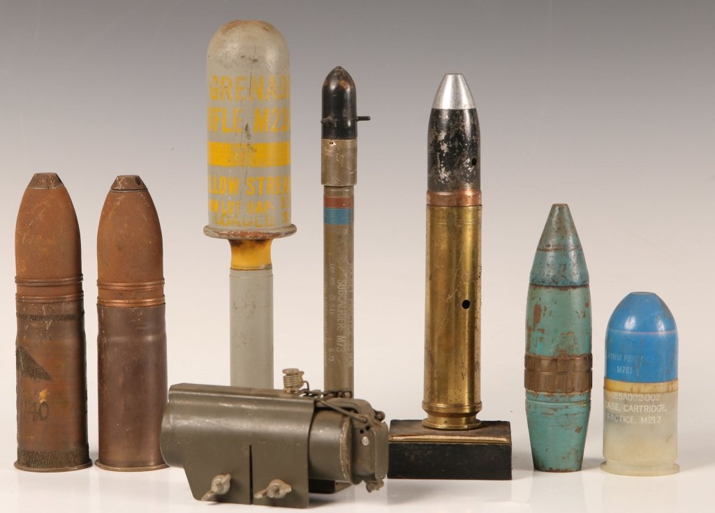 EIGHT PIECES OF ASSORTED U.S. MILITARY ORDNANCE, WWII: Interesting mixture of military munition to include M79 grenade launcher training round, military trip flare - 1961 dated, 30mm experimental cartridge mounted on wood base for aircraft 'gattling gun',