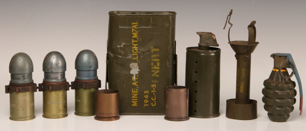 SEVEN PIECE US MILITARY ORDNANCE GROUPING: Seven pieces consisting of an anti-tank mine model M7A1 - 1945 dated and marked inert, practice or dummy smoke grenade, practice or dummy type M1 fragmentation grenade, M1A1 fragmentation grenade adap