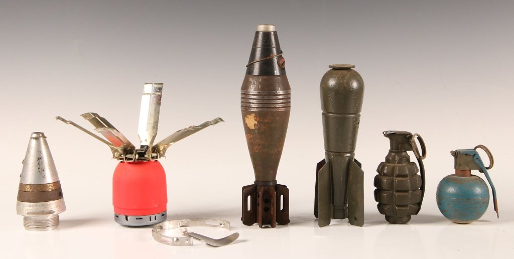 SIX PIECE US ORDNANCE COLLECTION: 75mm artillery shell timer fuse assembly, dummy or practice concussion grenade, dummy or practice M1 fragmentation grenade, 60mm mortar round, aerial projectile, spring loaded 'Bouncing Betty' bomb. W