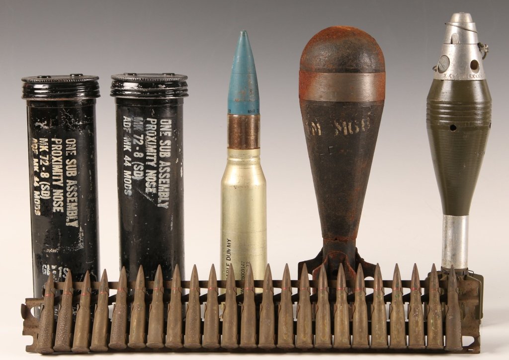 SIX PIECE ASSORTED MILITARY ORDNANCE COLLECTION: Lot consists of two mark 44 proximity nose fuse assembly tins for storage and transport, training 30mm round projectile and casing, 60mm mortar round with timer fuse head which is fairly complete, dum