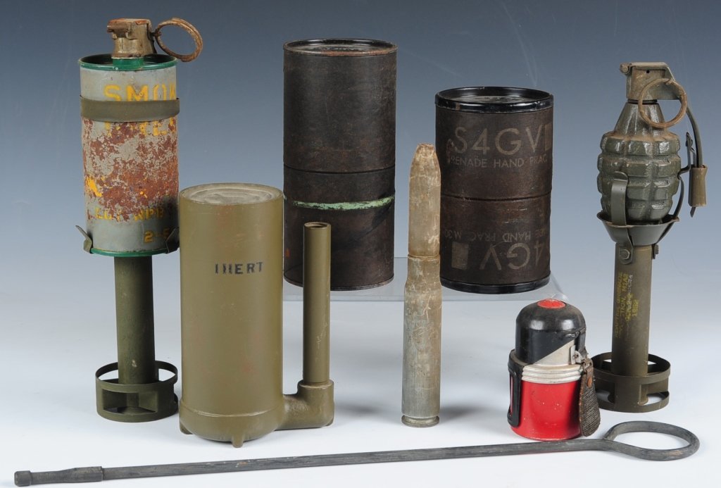 EIGHT PIECE MILITARY ORDNANCE COLLECTION: Consists of M1 fragmentation grenade and adapter for use as a rifle grenade, smoke grenade and adapter for use as rifle projectile, inert booby trip, two cardboard cartons: one for smoke grenade and t
