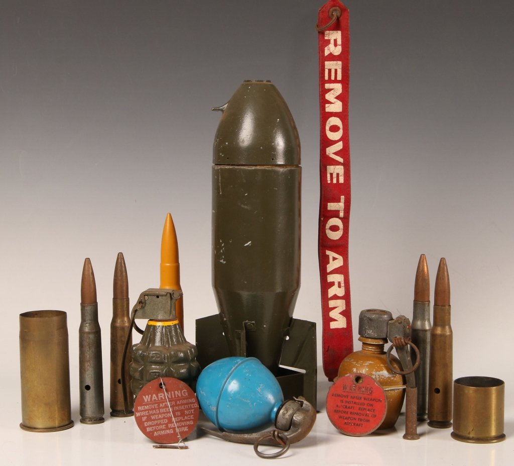 TWELVE PIECE MILITARY ORDNANCE COLLECTION: Large projectile dummy model, model 1916 Hodgekiss round shell casing, practice M1 fragmentation grenade, practice concussion grenade, two different styles of practice concussion grenades, a plastic 2