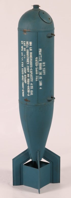 ONE HUNDRED POUND US NAVY AERIAL PRACTICE BOMB: Cylindrical sheet metal body with tail fins, light blue color to indicate an inert training unit. Appears complete, is well marked and dent free. Super display item. We ship in-house for all but very 