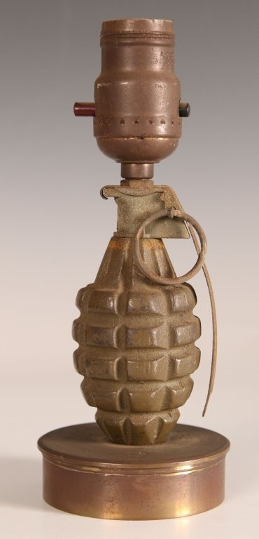 UNIQUE WWII TRENCH ART HAND GRENADE LAMP: Turned brass 75mm shell base inverted to form platform for lamp, body of lamp formed from original M1 fragmentation grenade that is complete with lever and safety pin. Lamp socket at top, interesting