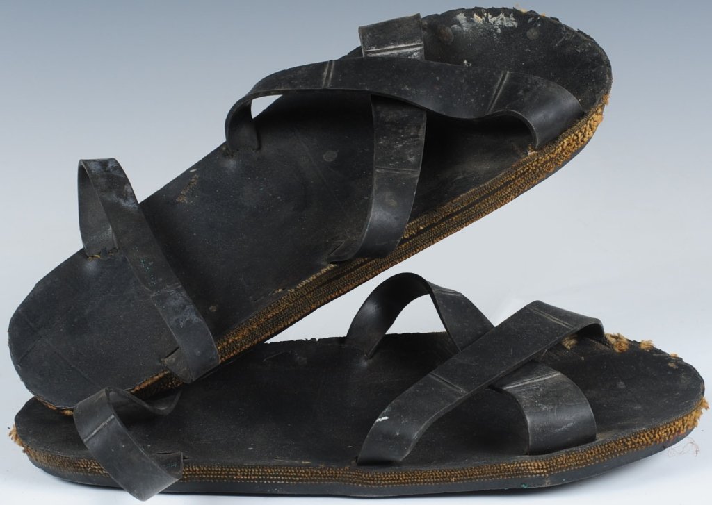 ORIGINAL VIETNAM WAR VIETKONG TIRE TREAD SANDALS: Interesting jungle workshop constructed black rubber sandals made from tire tread and inner tube straps. Famously recognized as foot gear of the Vietcong. Show normal use and wear. No damage or abuse.