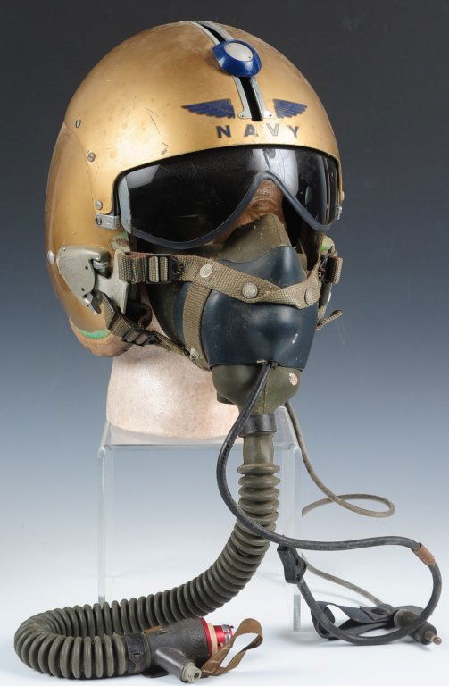 EARLY VIETNAM US NAVAL AVIATORS HELMET AND OXYGEN MASK: Gold finish shell winged navy decal on visor housing, tinted visor with distinct blue visor knob, wired with earphones, plug in cord, and includes rare oxygen mask with butterfly fasteners. Overall co