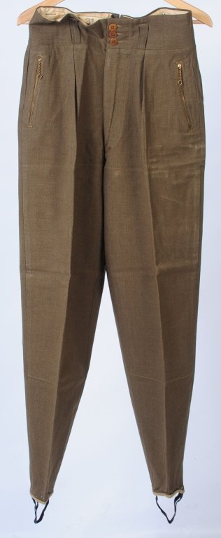WWII US ARMY MOUNTAIN SKI TROOP TROUSERS: Olive drab surge wool trousers with zippered frontal pockets, stirrup straps in cuffs for enclosing in ski boots, size 31/33 with original 1942 dated Quartermaster label inside. Minor age but appear u